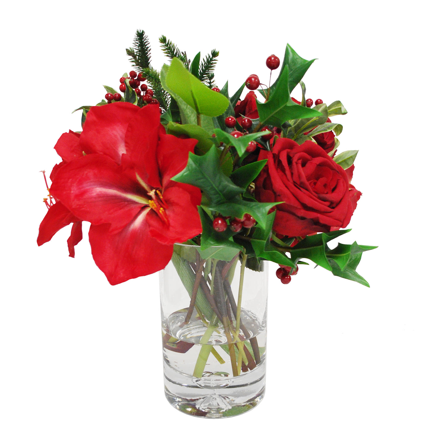 Elegant red amaryllis and rose floral arrangement with greenery in a clear glass vase, against a white background.